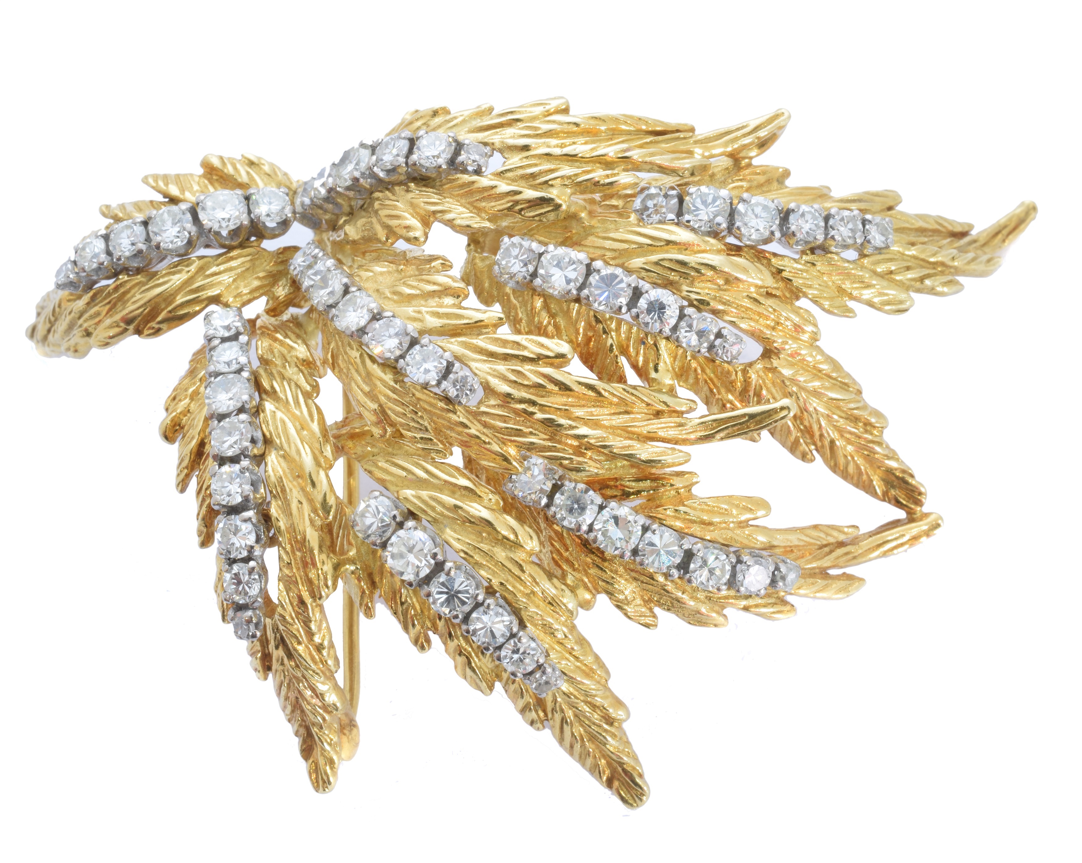 A 1960s 18ct diamond spray brooch by Ben Rosenfeld, designed as a textured foliate spray with single and brilliant cut diamond accents, maker's marks for Ben Rosenfeld, BRLd, hallmarks for London, 1968, estimated total diamond weight 2.30cts, length 6.4cm, gross weight 30.9g.
