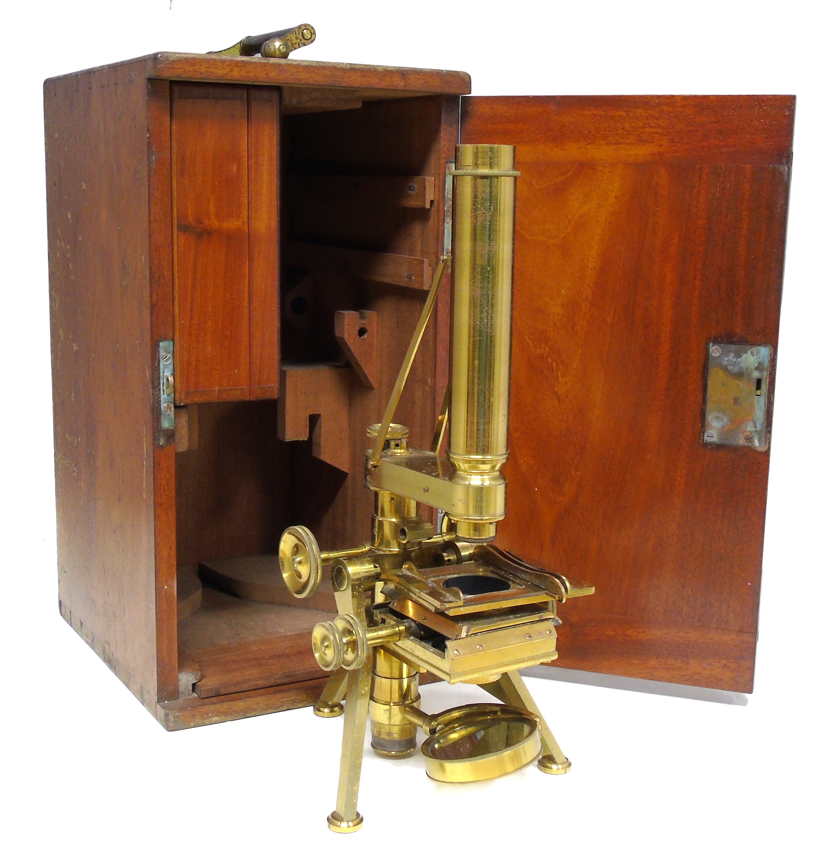 Monocular brass microscope by Powell & Lealand, Euston Road, London, contained in mahogany case, box of accessories including various eye pieces, microscope height 37cm (14").
