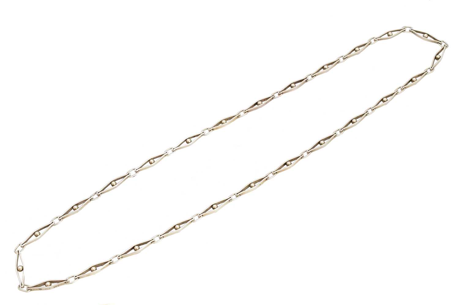 A silver Georg Jensen necklace, no. 285, the fancy link chain with polished spherical accents and trace link spacers, maker's marks for Georg Jensen, stamped 285, 925S, import marks for London, 1976, length 72cm, gross weight 42.2g, with maker's box.