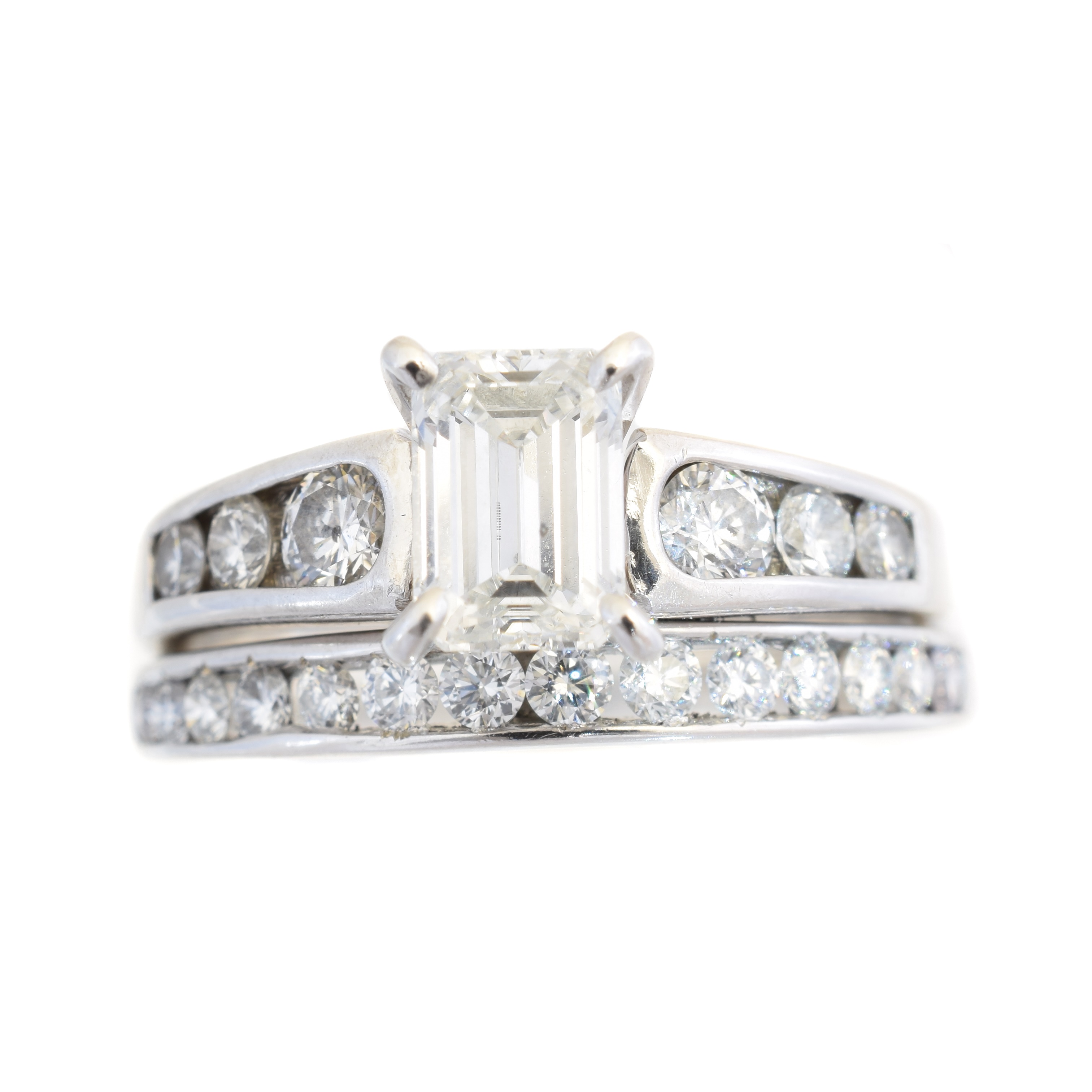 A diamond dress ring, the emerald cut diamond weighing 1.06cts with brilliant cut diamond shoulders and similarly cut adjoined diamond band, principal diamond with GSI 15708103301 inscription to girdle, relating to a certificate from Gemological Science International dated 2016 stating that the diamond is G colour, SI1 clarity, estimated total diamond weight 2cts, bands stamped 14k and 18k, ring size O, gross weight 6.4g.
