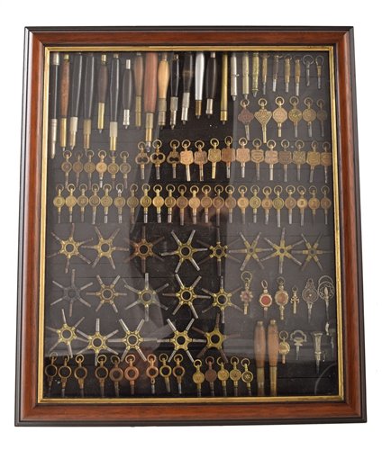 Lot 1 - Small wall display cabinet containing various watch maker's tools and keys