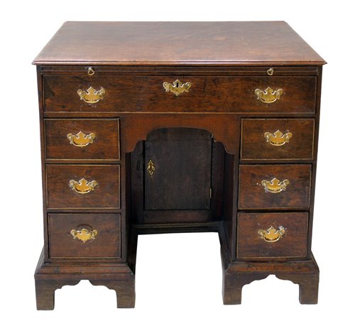 Lot 351 - George III oak knee-hole desk.