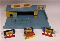 Lot 61 - Two Matchbox No. 1 Accessory Packs (Esso pumps and sign), boxed, No. 3 pack garage boxed, two unboxed pumps and oil dispenser complete with wooden garage bearing Shell, BP and Lucas signs.