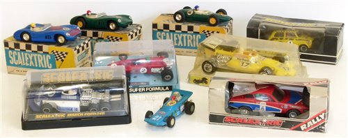 Lot 69 - Scaletrix March Ford 240 (6 wheeler), 1961 Lotus MM/C63, two Aston Martins MM/C57 (blue and green), Ferrari 312B.2, Triumph TR7 C130-0020 and Mini Rally 1275 GT Special C.122, all boxed complete wi...