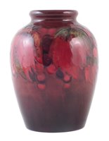 Lot 77 - Moorcroft flambe vase, decorated with leaves and berries pattern