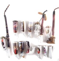 Lot 48 - Four hand painted continental porcelain pipes together with a collection of other continental porcelain pipes