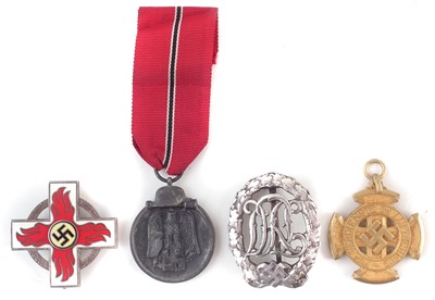 Lot 311 - Four German Third Reich WWII medals / badges