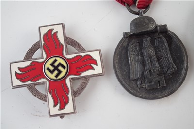 Lot 311 - Four German Third Reich WWII medals / badges
