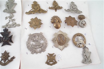 Lot 217 - Sixty six cap badges mounted on cards