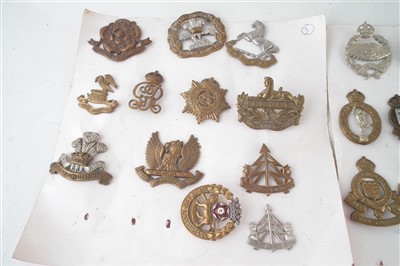 Lot 217 - Sixty six cap badges mounted on cards