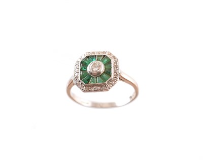 Lot 211 - A platinum emerald and diamond dress ring