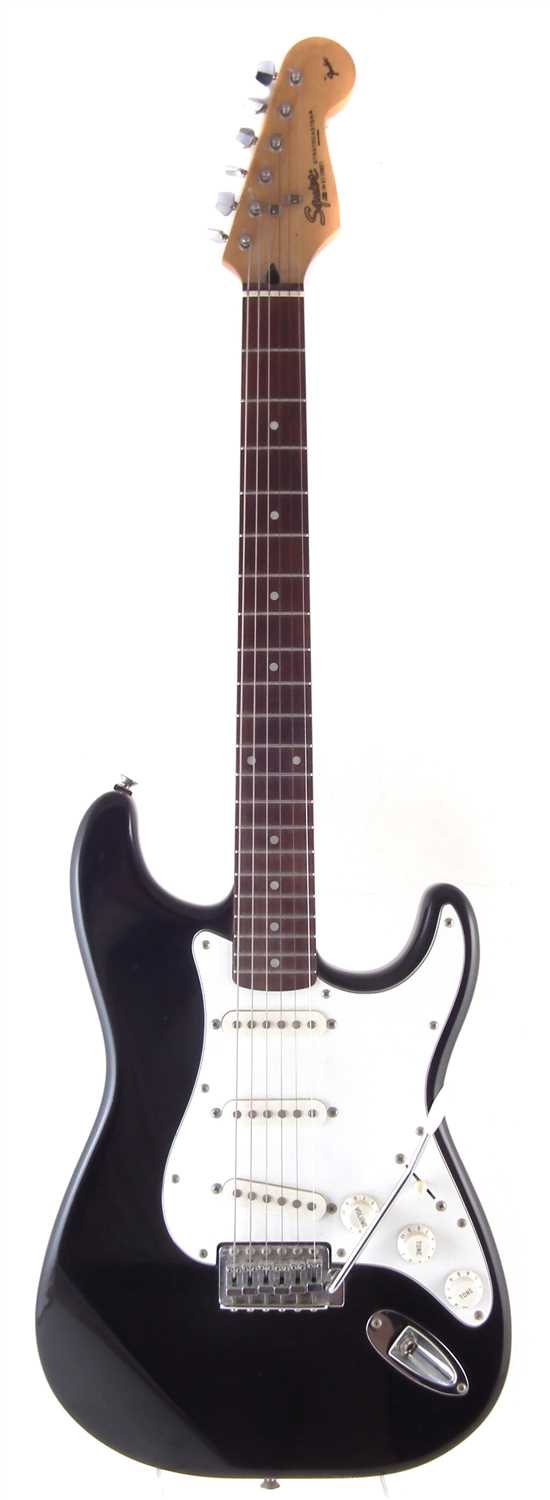 Lot 60 - Squier by Fender stratocaster with accessories.