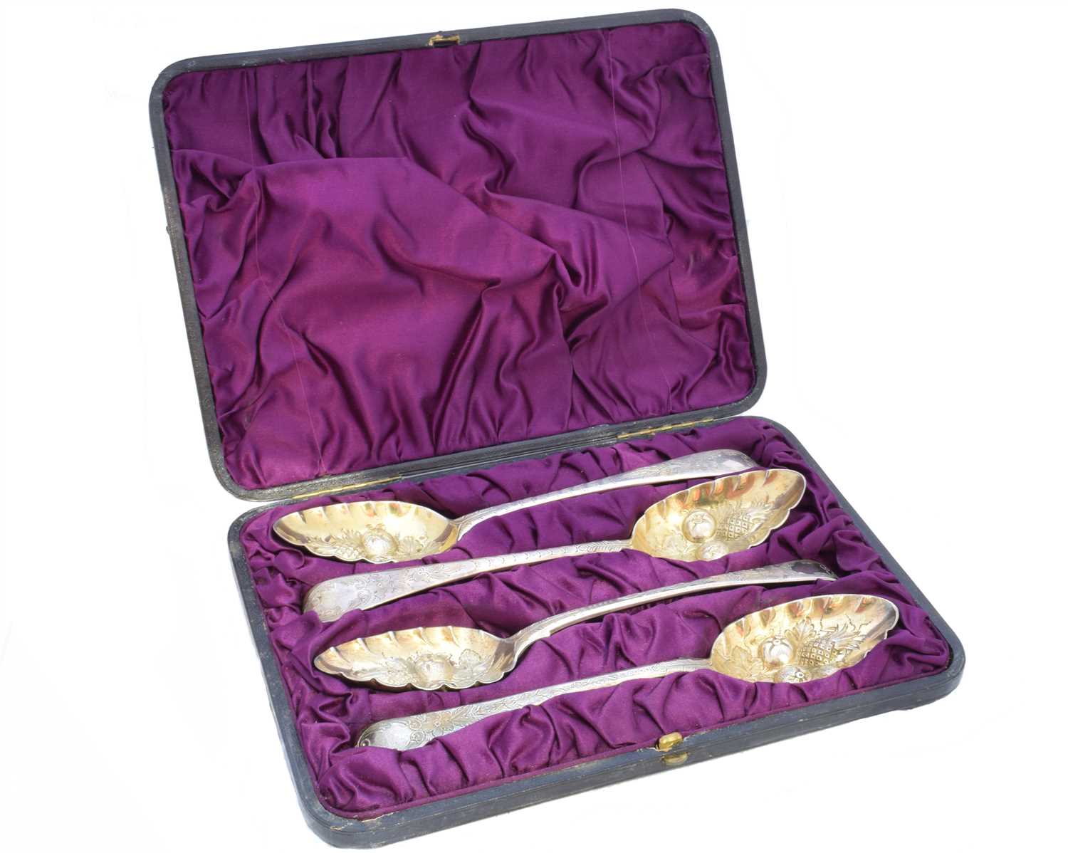 Lot 2 - A cased set of four George III silver berry spoons