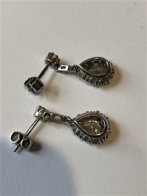 Lot 104 - A pair of diamond drop earrings
