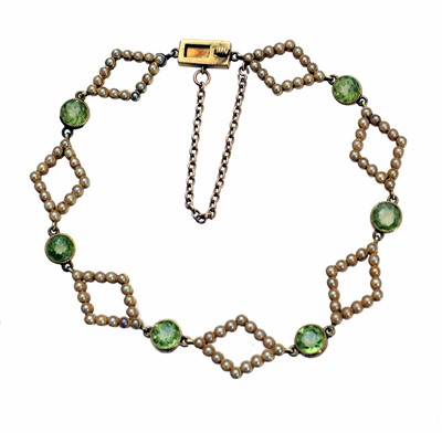 Lot 66 - An early 20th century peridot and split pearl bracelet.