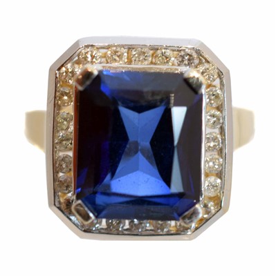 Lot 226 - A synthetic sapphire and diamond cluster ring