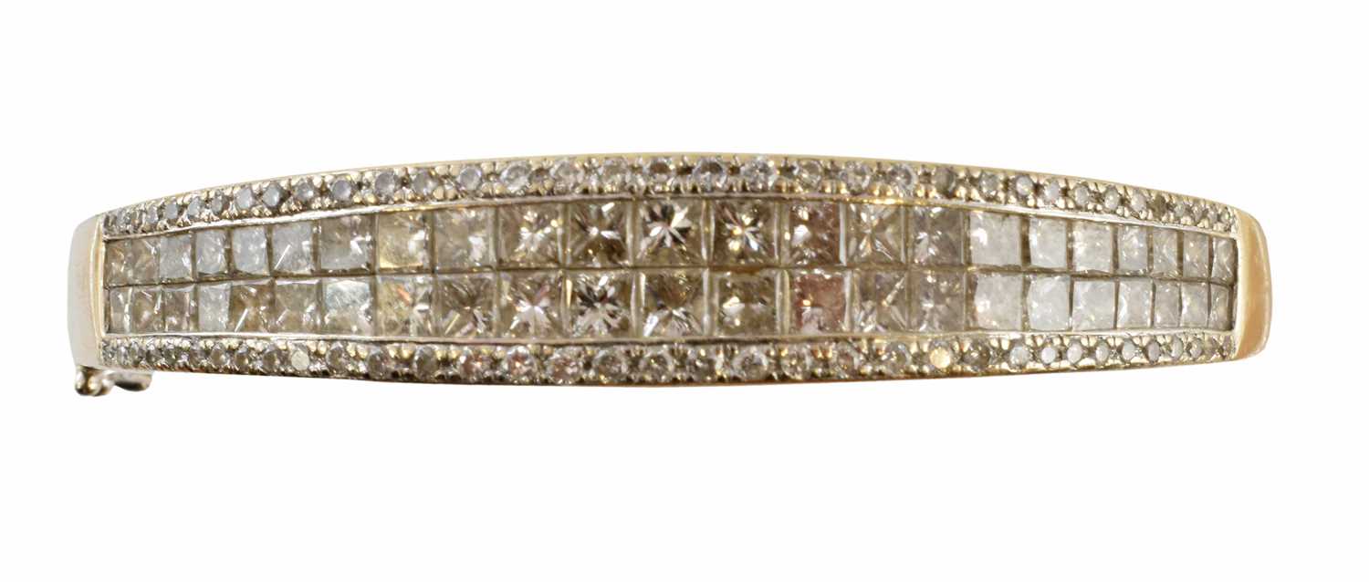 Lot 53 - An 18ct gold diamond hinged bangle