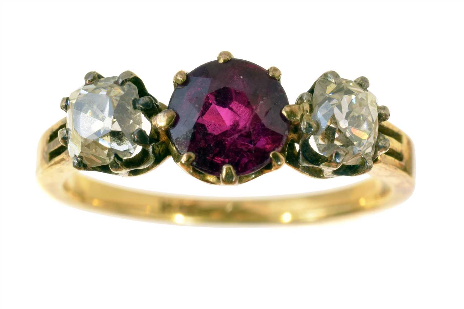 Lot 122 - A ruby and diamond three stone ring.