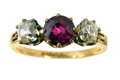 Lot 122 - A ruby and diamond three stone ring.