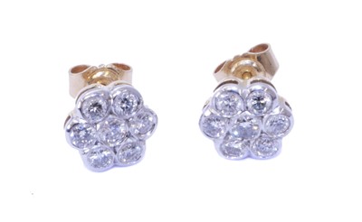 Lot 125 - A pair of 18ct gold diamond cluster earrings