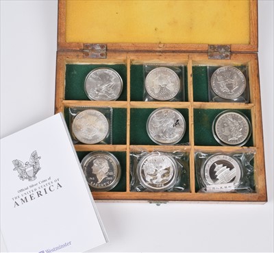 Lot 10 - Box containing seven USA Dollar coins and two silver Chinese 1oz Panda coins.