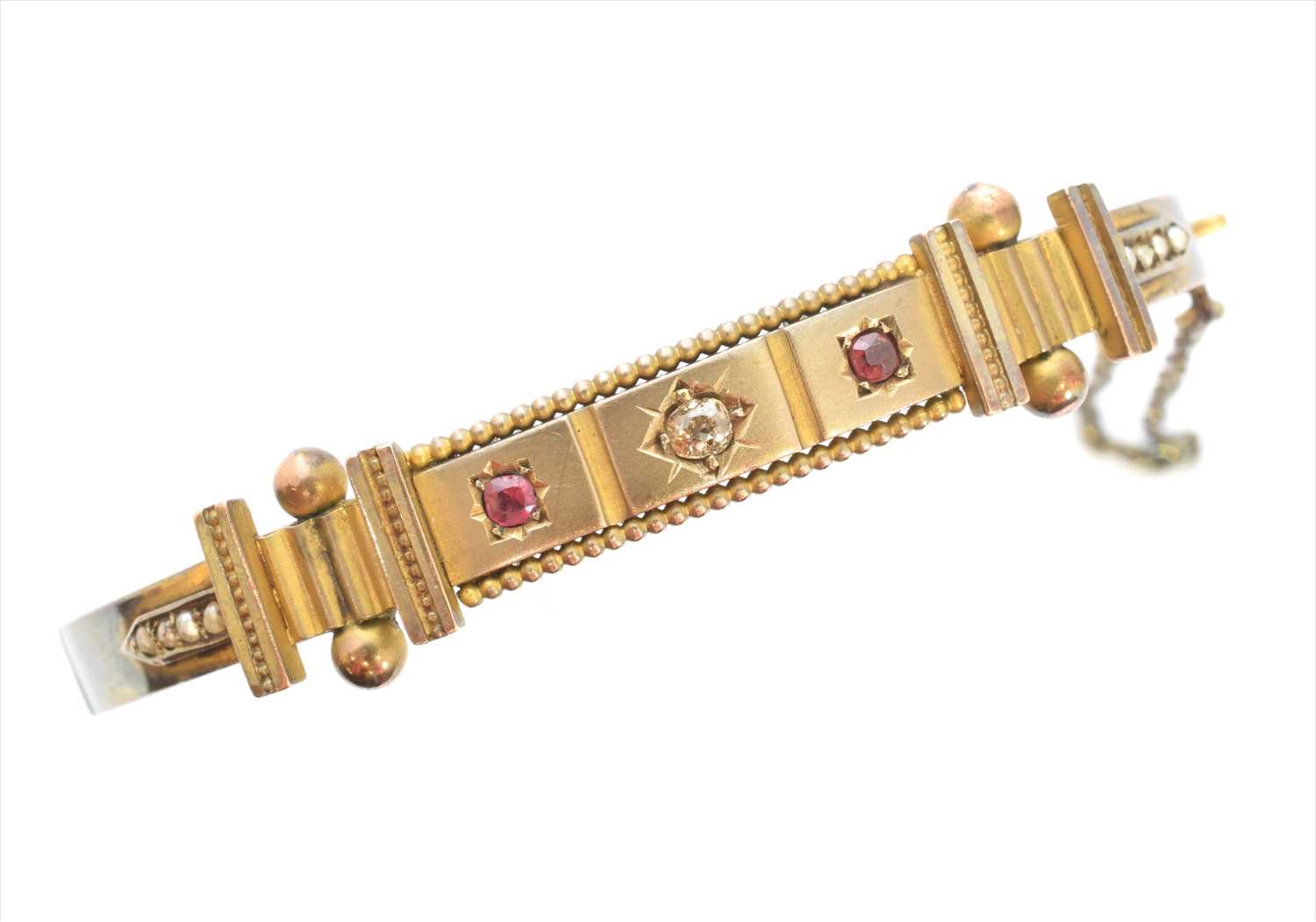 Lot 12 - A late Victorian diamond, ruby and split pearl bangle