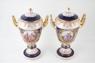 Lot 137 - A pair of Dresden twin handled lidded vases