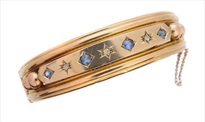 Lot 5 - A late Victorian sapphire and diamond hinged bangle
