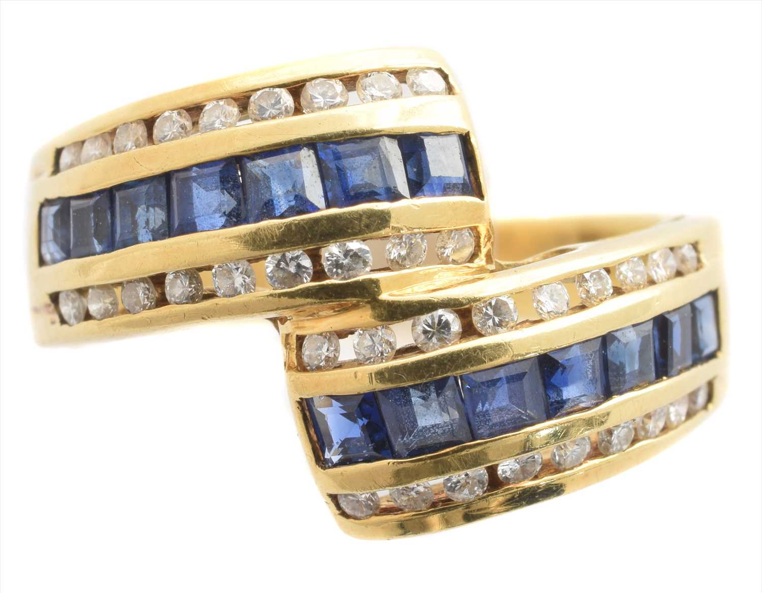 Lot 268 - A sapphire and diamond crossover ring