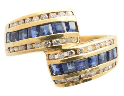 Lot 268 - A sapphire and diamond crossover ring