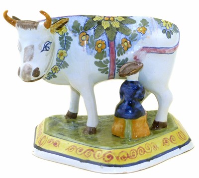 Lot 116 - Delft cow and milkmaid group, the base marked O.U.D. Delft, late 19th century