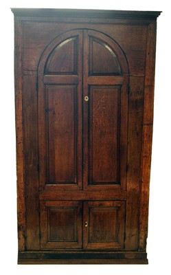 Lot 211 - George III oak floor standing corner cupboard