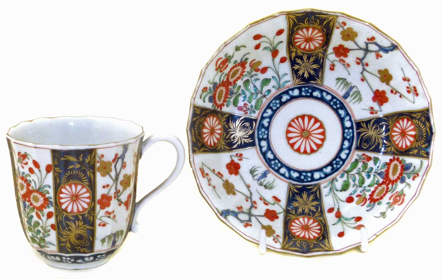 Lot 76 - Worcester faceted cup and saucer decorated with a Kakiemon style pattern (chip to saucer only)