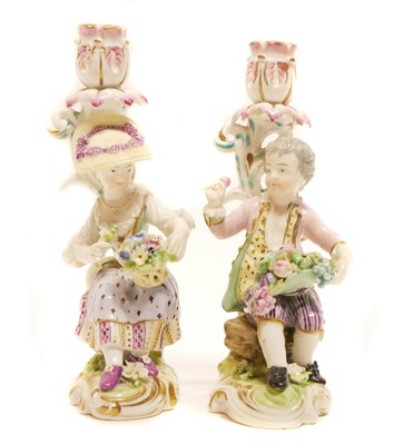 Lot 158 - Pair of Derby candlestick figures of a seated boy and girl