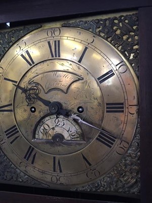Lot 134 - Longcase clock by Wooley with brass dial and carved oak case.
