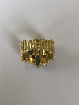 Lot 154 - An 18ct gold turquoise and ruby band ring