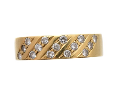 Lot 220 - An 18ct gold diamond band ring