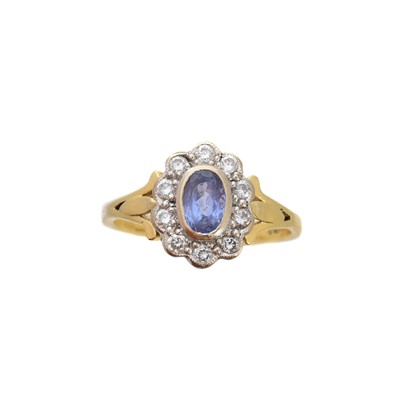 Lot 180 - An 18ct gold tanzanite and diamond cluster ring
