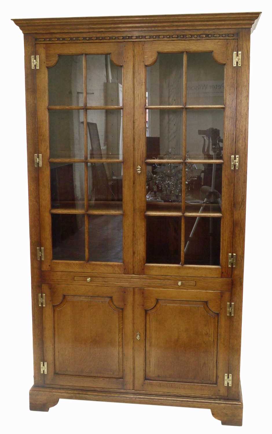 Lot 383 - A late 20th-century honey-coloured oak display cabinet on cupboard