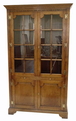 Lot 383 - A late 20th-century honey-coloured oak display cabinet on cupboard