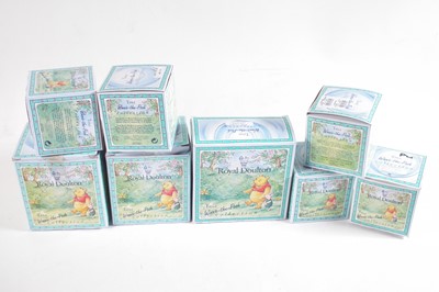 Lot 123 - Seven Royal Doulton Winnie the Pooh boxed figures and a money box