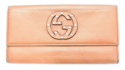 Lot 27 - A Gucci logo trifold long wallet