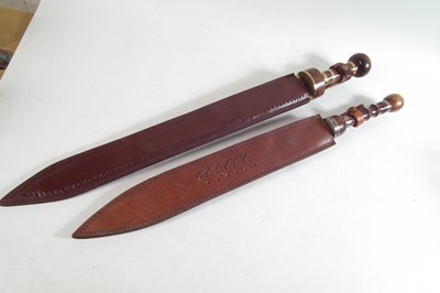Lot 357 - Two modern replicas of a Roman Sparta cavalry sword and scabbard