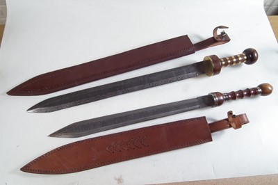 Lot 357 - Two modern replicas of a Roman Sparta cavalry sword and scabbard