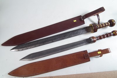 Lot 357 - Two modern replicas of a Roman Sparta cavalry sword and scabbard