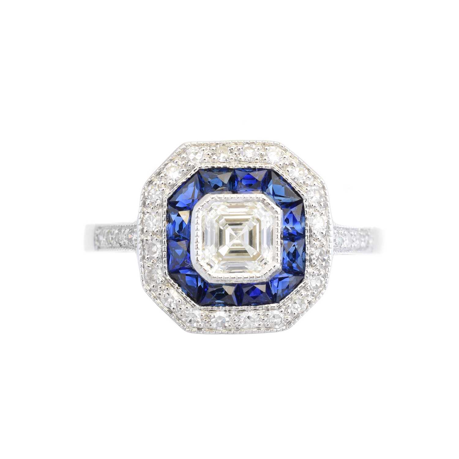 Lot 100 - A diamond and sapphire cluster ring