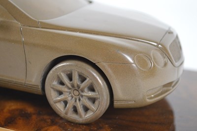 Lot 40 - bronzed resin desk ornament of a Bentley Continental GT on a lustrous wooden base
