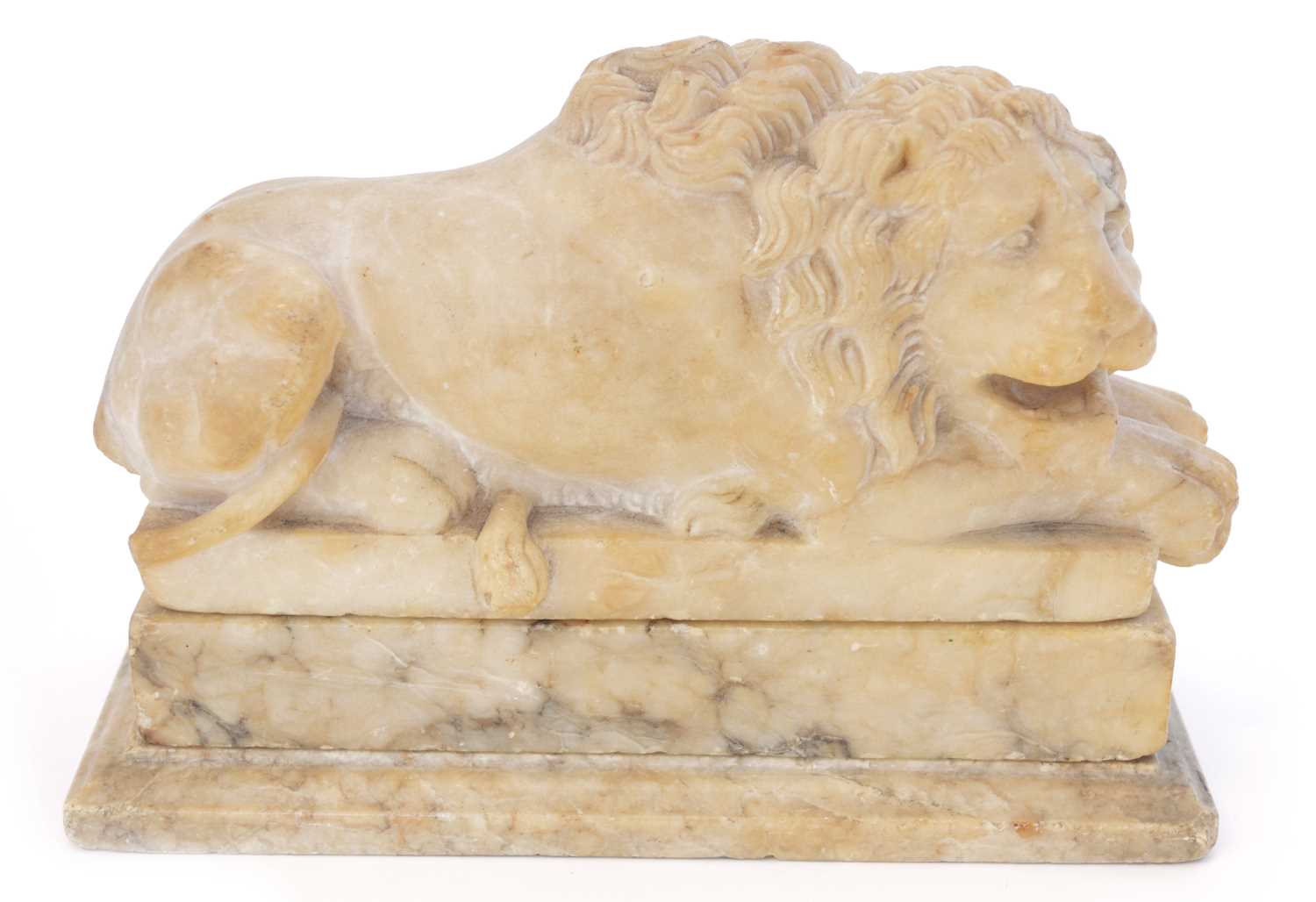 Lot 234 - A 19th soapstone figure of a sleeping lion.