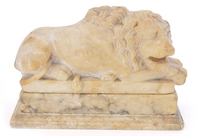 Lot 234 - A 19th soapstone figure of a sleeping lion.