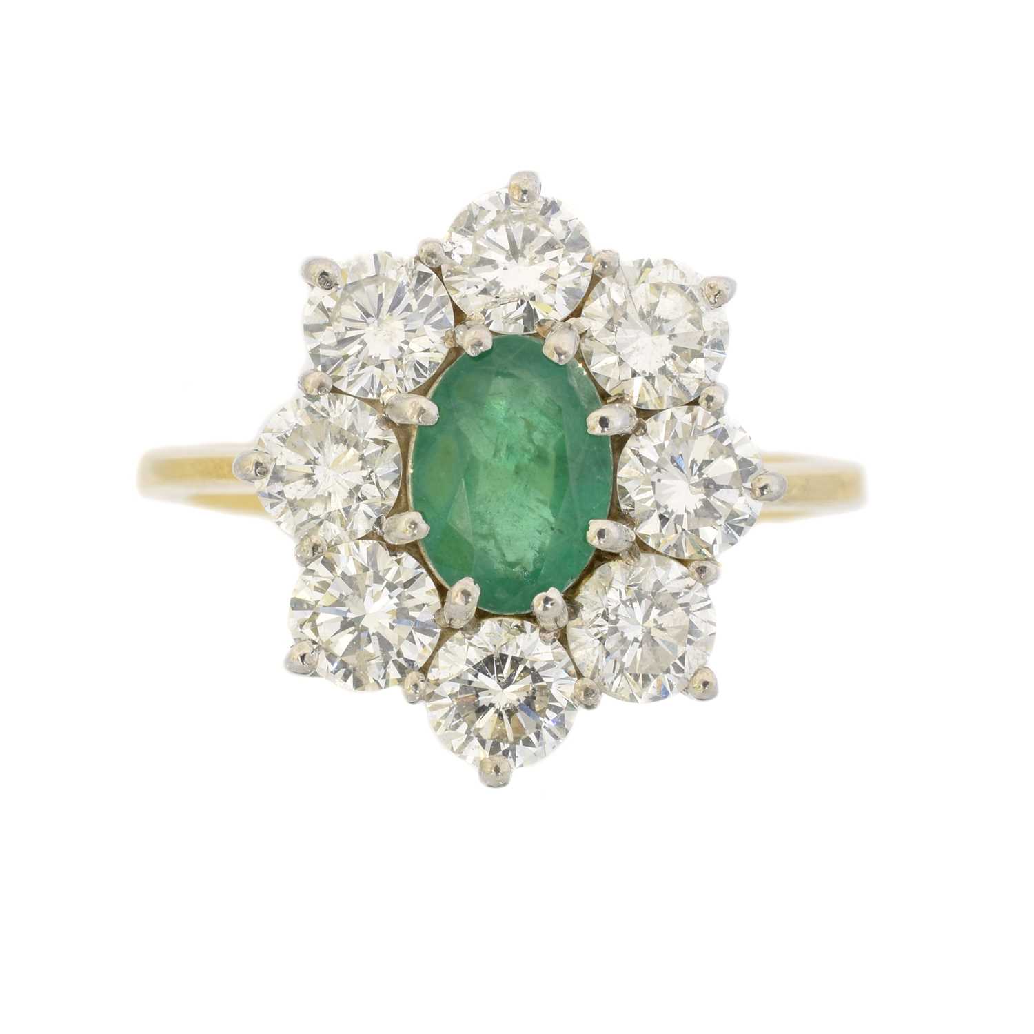 Lot 102 - An 18ct gold emerald and diamond cluster ring